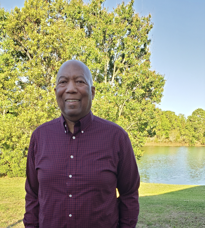 Keith Hamilton standing in front of a lake in Florida